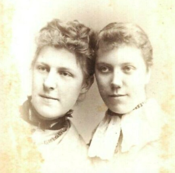 Cartes-de-Visite photograph from the 1880s showing two young women in a head and shoulder shot. The woman on the left learns towards the other women and their heads are touching.
